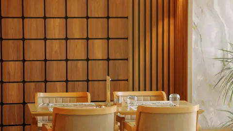 Restaurant tables and chairs arranged in a warm wood interior.